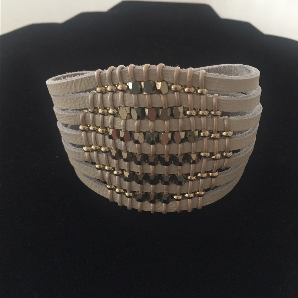 Faux-leather bracelet with gold beads.